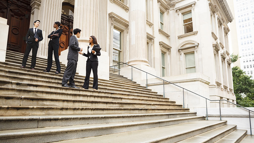 people standing on the steps of a capital building