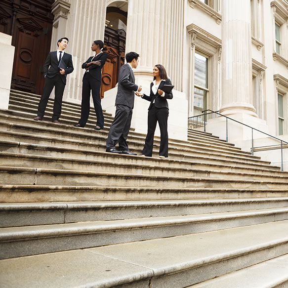 people standing on the steps of a capital building